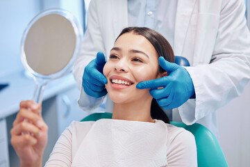 Dentist, mirror and woman with smile after consulting for teeth whitening, service and dental care....