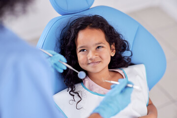 Dentistry, happy and kid patient at dentist for teeth cleaning, oral checkup or consultation. Healthcare, smile and girl child laying on chair for dental mouth examination with equipment in a clinic.