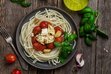 Italian pasta. Spaghetti with baked feta cheese and tomatoes in a bowl