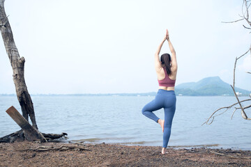 The asian woman do yoga in holiday time, on modern concept and healthy. Nature  background with exercise and nature, female happiness concept