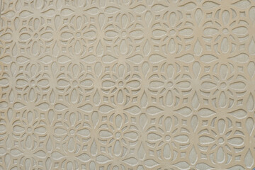 Traditional floral decorative pattern of beige colour on the wall of houses in the historic Jewish quarter of Segovia, Spain. Spanish decoration technique sgraffito or esgrafiato