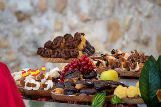 Churros filled with chocolate. Typical Spanish artisanal pastry. Appetizing sweet dish, tasty dessert. Ready to go snack. Take away meal. Street pastries, medieval market. Traditional urban food Spain