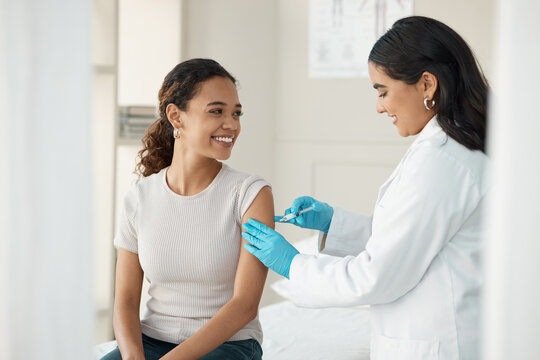 Injection, vaccine and patient at the clinic for consulting and help with prevention with a smile. Doctor, inject and woman on arm for virus with gloves in medical room for wellness or health.