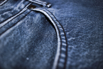 The texture of the blue jeans with the detail of the fabric.