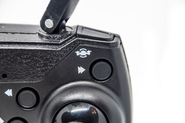 Buttons on the remote control of the quadcopter on a white background close-up	
