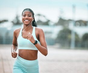 Portrait, outdoor and black woman running, exercise and training for wellness, health and self care. Face, female person or runner with earphones, workout goal and athlete with music, smile or cardio