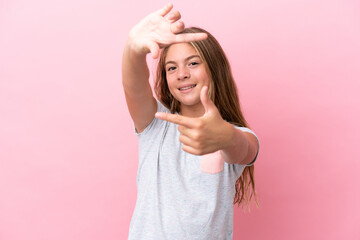 Little caucasian girl isolated on pink background focusing face. Framing symbol
