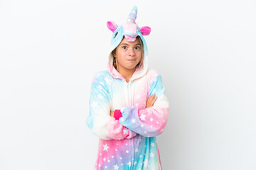 Little girl with unicorn pajamas isolated on white background making doubts gesture while lifting the shoulders