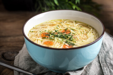 Broth - chicken soup in a blue bowl.