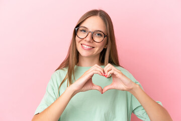 Young Lithuanian woman isolated on pink background With glasses making heart with hands