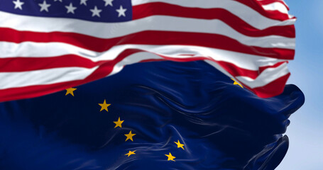 Alaska state flag waving in the wind behind the national flag of the US