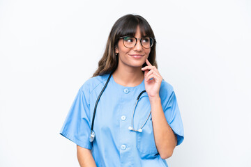 Young caucasian nurse woman isolated on white background thinking an idea while looking up