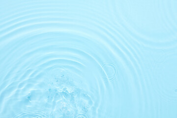 Naklejka na ściany i meble Water blue surface abstract background. Waves and ripples of cosmetic moisturizer with bubbles