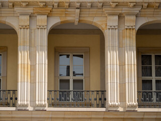 Obraz premium View from the street of an old, elegant facade of a house in Berlin, with decorative details in stone walls and railings on the balcony. Berlin houses.
