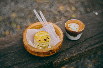 delicious freshly baked homemade scones on wooden bowl with morning coffee.