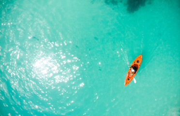 Adventurous Canoeing in a Tropical Paradise: Aerial Perspective of an Unrecognizable Tourist Exploring Exotic Waters