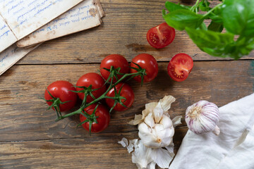 fresh cherry tomatoes and garlic on wooden board 