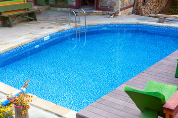 Clear blue pool in the yard. Rest and relaxation