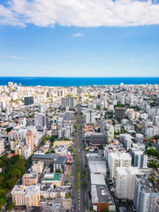 Vertical aerial view above Abraham Lincoln street and Caribbean sea. Skyscrapers and office...