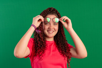 Teenager with red curly hair, wearing jeans, shirt, glasses and with various facial expressions of feelings