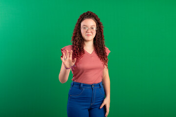 Fototapeta premium Teenager with red curly hair, wearing jeans, shirt, glasses and with various facial expressions of feelings