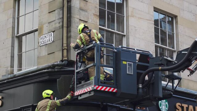 Edinburgh, Scotland - scottish fire engines United Kingdom, Tape that says Fire, Do Not Cross cordons off the scene of a fire while London Fire Brigade are at work. engine on street
