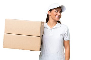 Delivery caucasian woman holding boxes isolated on green chroma background looking side