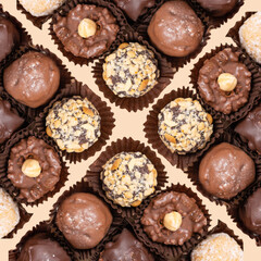Chocolate craft nuts candies on beige background flat lay, top view
