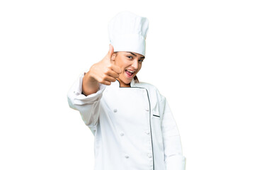 Young woman Chef over isolated chroma key background with thumbs up because something good has happened