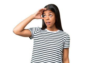 Young African american woman over isolated background doing surprise gesture while looking to the side