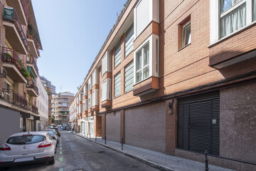 Fototapeta na wymiar A narrow city street with low-rise buildings