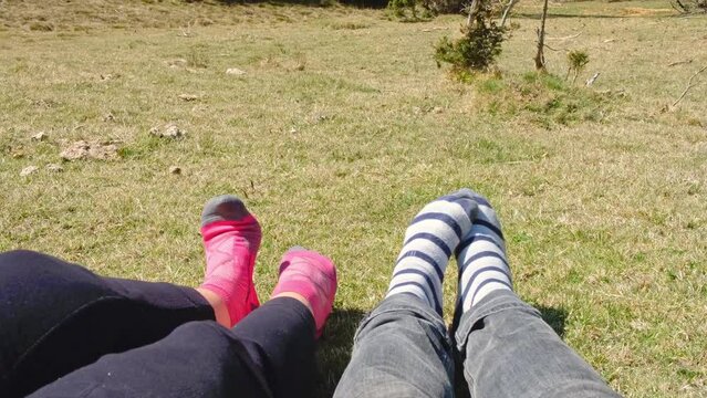 two feet in socks, feet dancing happily in the sun, nature and good weather on vacation
