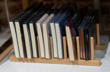 A group of elegant and fancy notebooks in a shelf