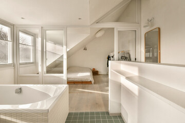 a bathroom with a bathtub in the middle and a bed on the other side, next to a window