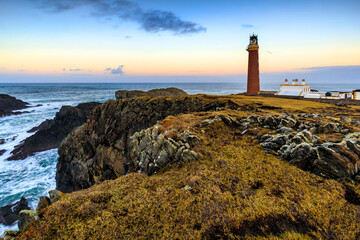 Butt of lewis lighthouse at sunset, located on the rugged coastline in the isle of Lewis, Outer...