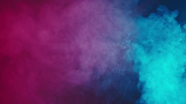 Abstract blue and pink smoke moves on a black background in neon light. Rolling smoke. Texture and abstract art.