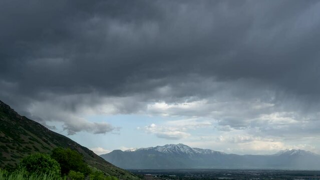 Timelapse of storm clouds moving over Utah Valley viewing Loafer Mountain and Mt. Nebo in the background.
