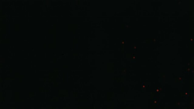 Heated embers VFX fire element  sparks fly through the frame in a captivating slow-motion 4K&mdash;the mesmerising beauty of fire particles and flying embers against a black screen. 