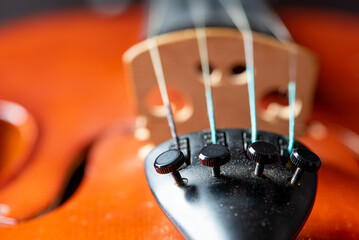 Violin, details of a beautiful violin on rustic wood, low key style photo, black background,...
