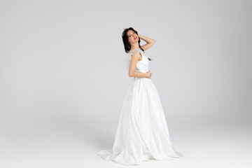 Beautiful bride in elegant white dress. isolated on white background. full length