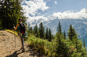 Woman hiking in the mountains with a view of the Chamonix glacier