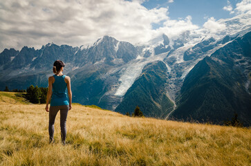 Woman looking out over the Bossons glacier and Mont Blanc in the Chamonix mountains