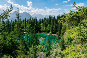 Beautiful blue and green lake with pines and mountains