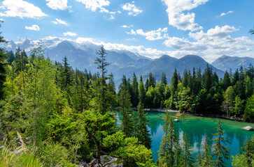 Beautiful blue and green lake with pines and Mont Blanc mountain