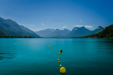 Amazing view of blue Lake Annecy with yellow buoys