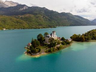 Charming little island with castle on the blue lake Annecy