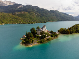 Charming little island with castle on the blue lake Annecy