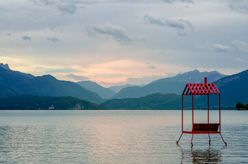 Amazing sunset over lake Annecy, mountains and hammock