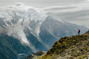 Amazing view with a woman scanning the Mont Blanc and glaciers