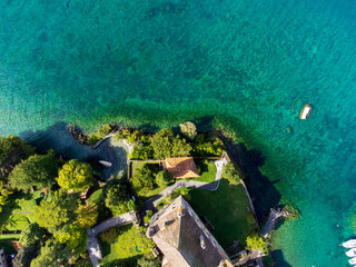 Impressive and colourful drone view of an island on Lake Annecy